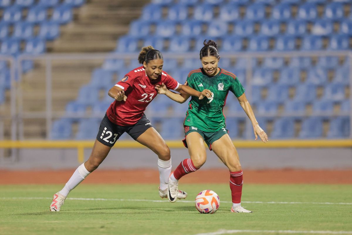 Trinidad and Tobago's Shaunlee Govia, left, battles with Mexico’s Kiana Palacios during the Road to Concacaf W Gold Cup match at the Hasely Crawford Stadium in Mucurapo, Port-of-Spain on Tuesday, December 5TH 2023. Mexico won 1-0. PHOTO BY: Daniel Prenti