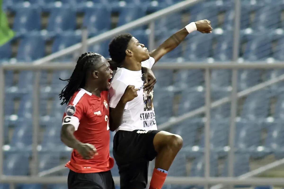 After scoring the game-winning goal against Curaçao, Trinidad and Tobago's Nathaniel James (right) displays a shirt in honor of his murdered friend Kaylon Jacob. The Concacaf Nations League match took place at the Hasely Crawford Stadium on Thursday, September 7th 2023.
