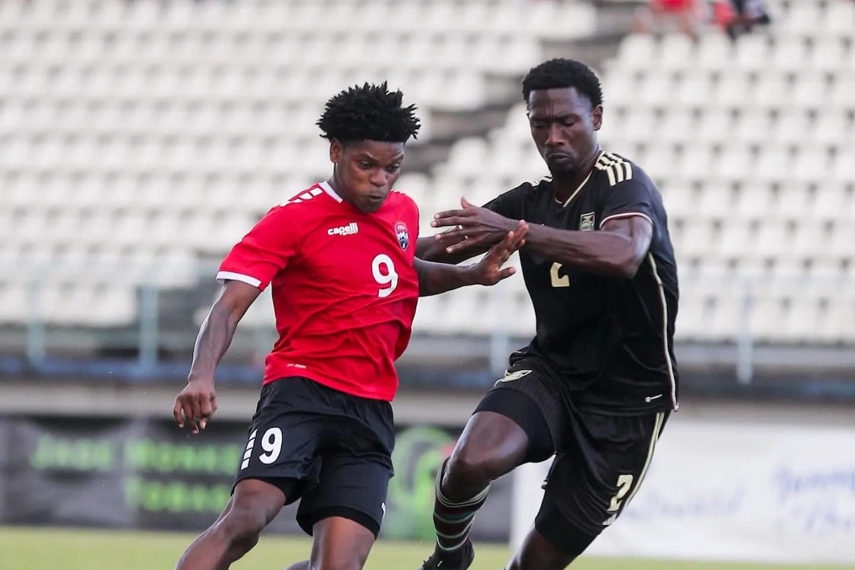 Trinidad and Tobago forward Nathaniel James (left) holds off Jamaica defender Joel Cunningham during friendly international action at the Larry Gomes Stadium in Malabar on 3 March 2024. ...Photo: Daniel Prentice
