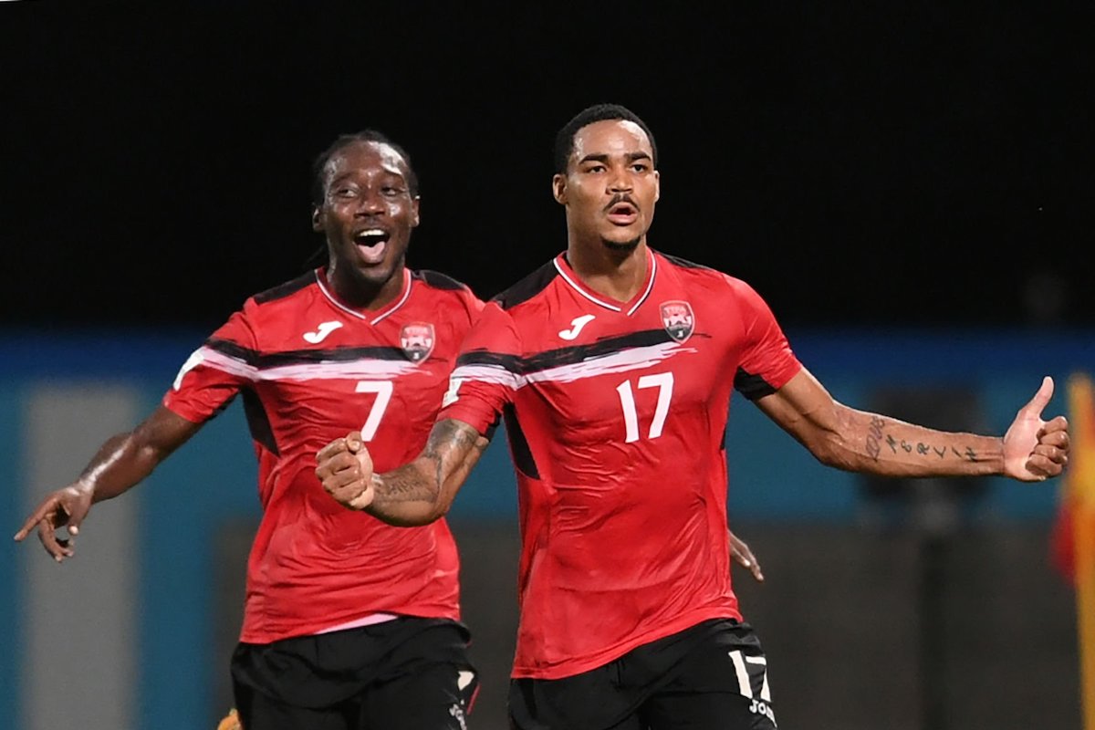 Trinidad and Tobago's Alvin Jones (R) celebrates after scoring against United States during their 2018 World Cup qualifier football match in Couva, Trinidad and Tobago, on October 10, 2017. / AFP PHOTO / Luis ACOSTA (Photo credit should read LUIS ACOSTA/AFP via Getty Images)