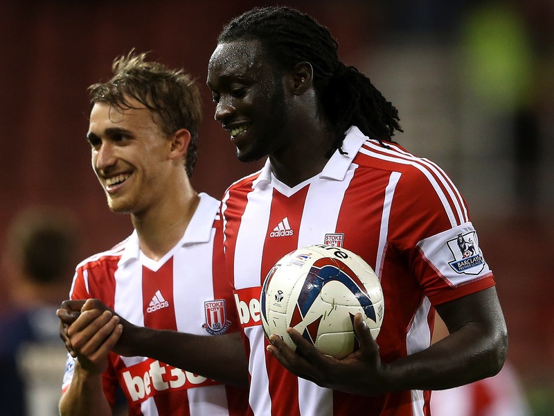 Kenwyne Jones of Stoke celebrates with Marc Muniesa after scoring his hat trick and claiming the match ball during the Capital One Cup Second Round match between Stoke City and Walsall at Britannia Stadium on August 28, 2013 in Stoke on Trent, England.