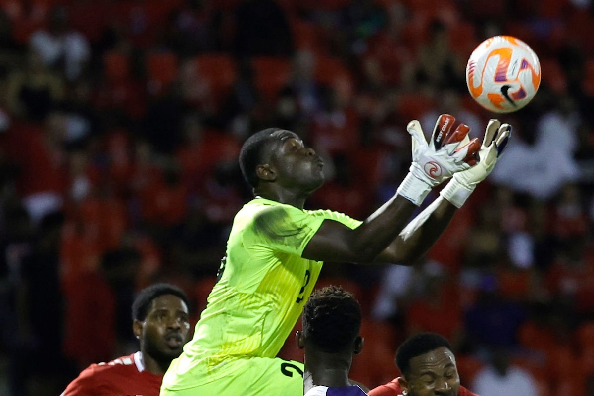 Denzil Smith #22 of Trinidad and Tobago gathers the ball as Folarin Balogun #20 of the United States attacks during the first half at Hasely Crawford Stadium on November 20, 2023 in Port of Spain, Trinidad And Tobago. (Photo by Carmen Mandato/USSF/Getty Images for USSF)