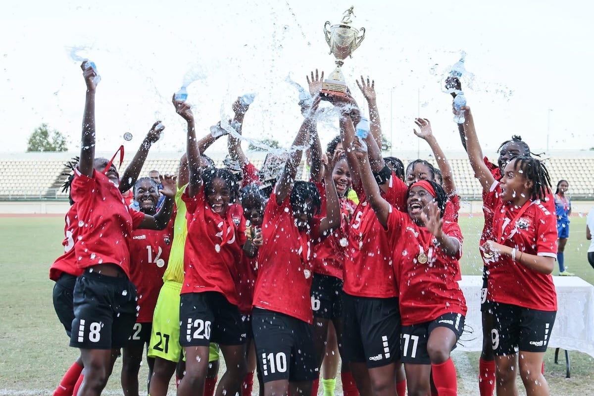 T&T "A" celebrate winning the Jewels of the Caribbean invitational football tournament, at Larry Gomes Stadium, Malabar, Wednesday. - Angelo Marcelle