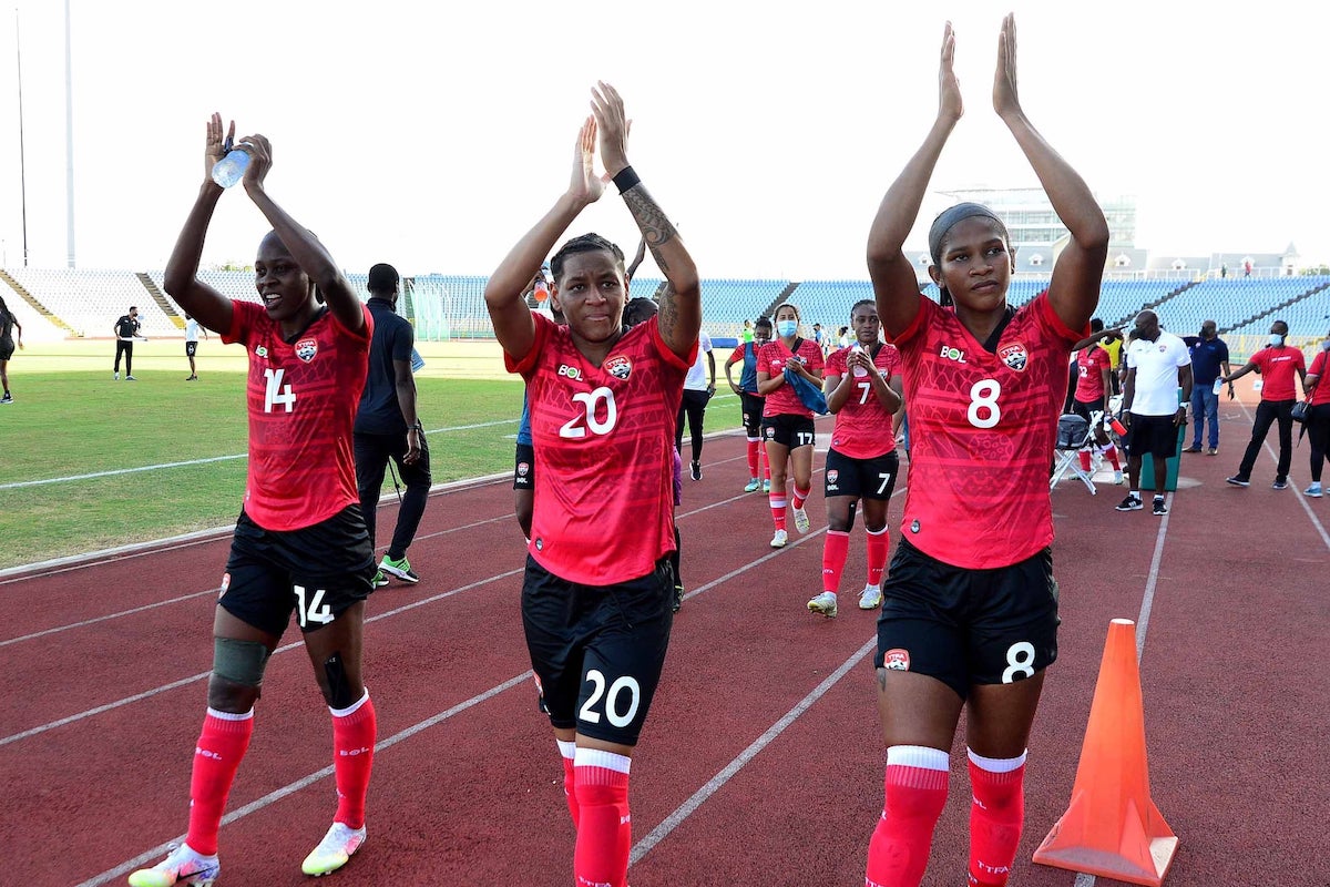 Karyn Forbes (#14), Lauryn Hutchinson (#20), and Victoria Swift (#8) applaud the fans after Trinidad and Tobago Women's 2-1 win over Nicaragua on February 17th 2022 ash the Hasely Crawford Stadium, Port of Spain, Trinidad and Tobago