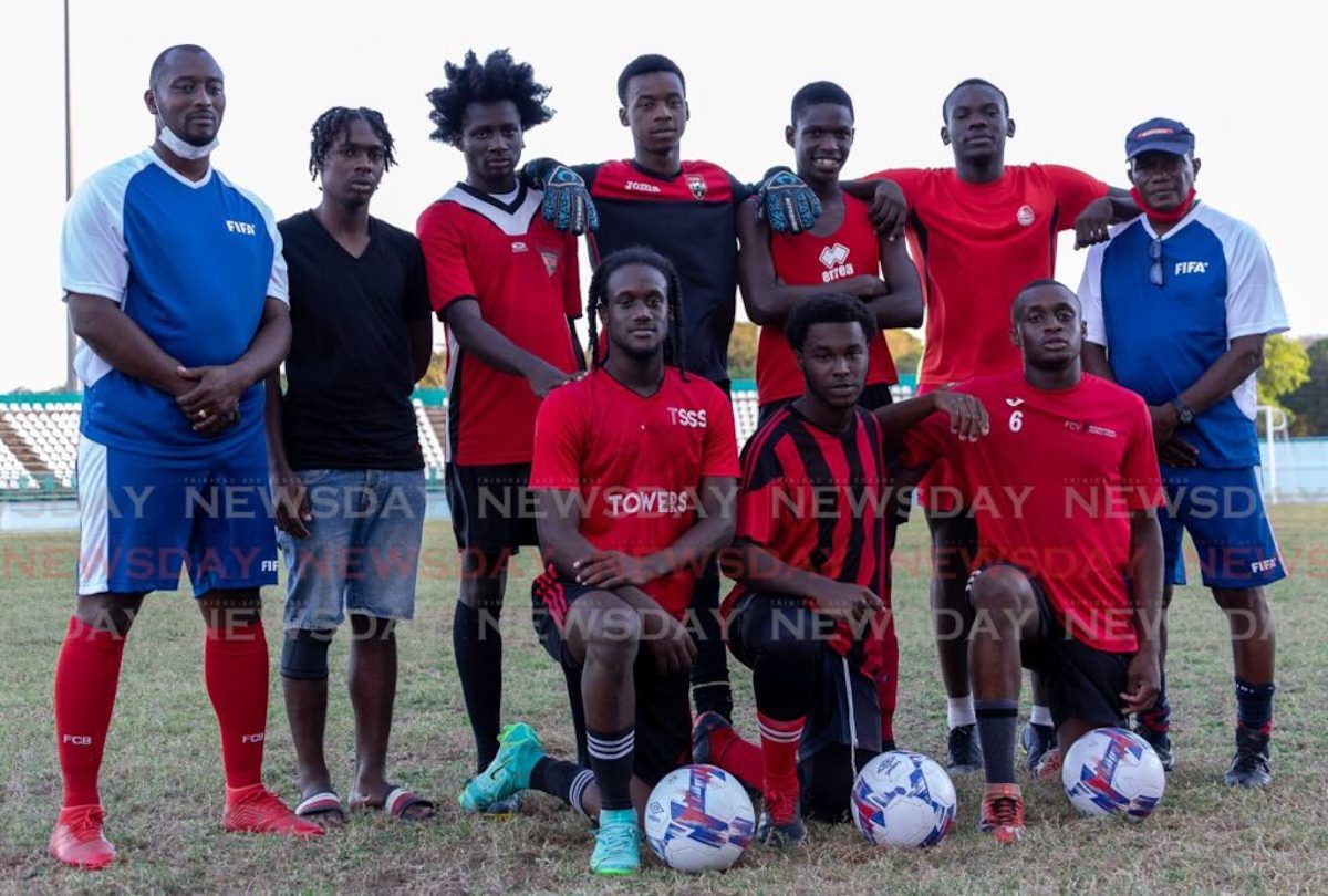 Tobago footballers alongside coaches Richard Goddard, left, and Terry Williams, right, at the Dwight Yorke Stadium, Bacolet. The eight were shortlisted to train with the national under-20 team. Photo by David Reid