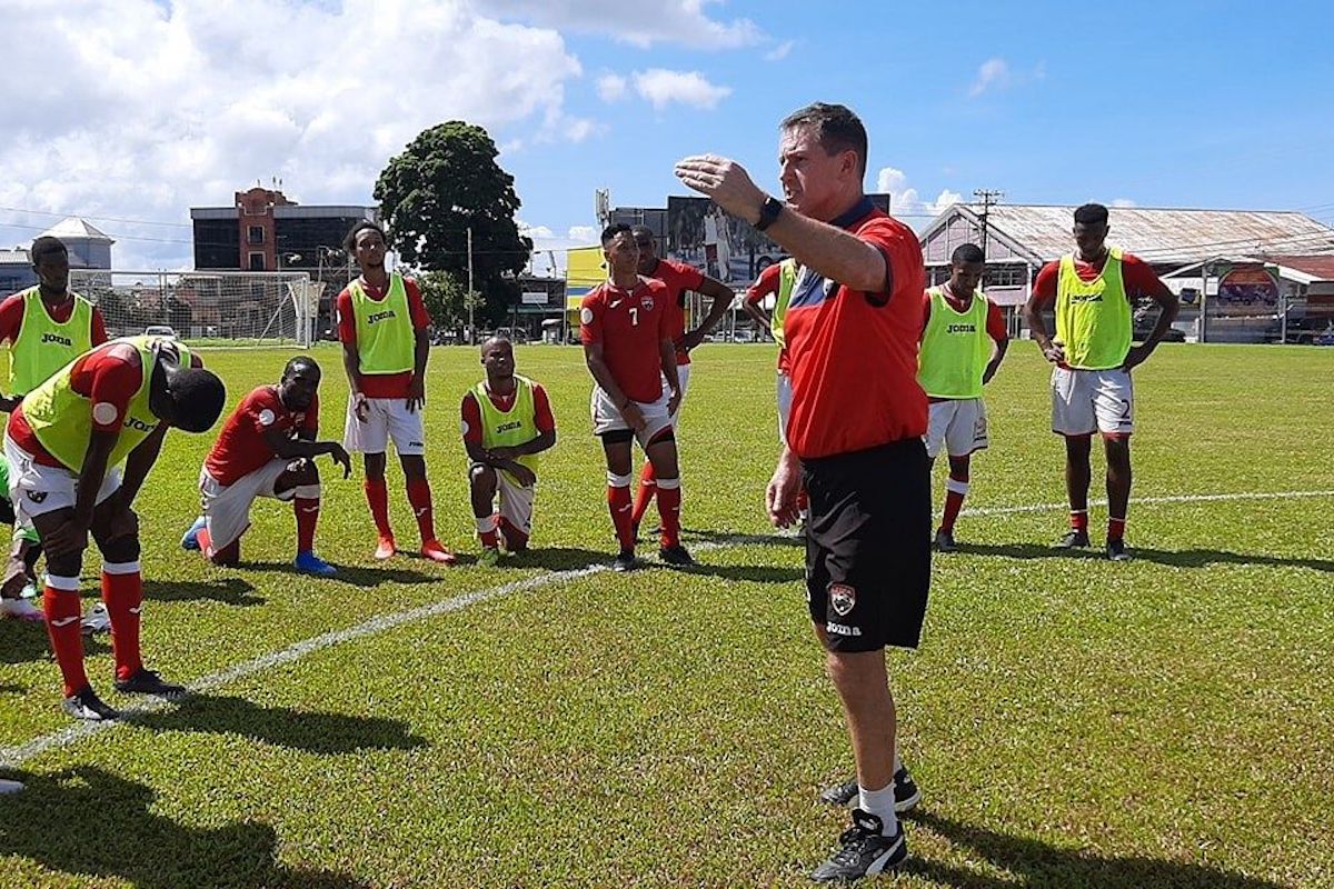 National senior team men’s head coach Terry Fenwick gives instructions to his players as the team resumed training last month at the the St James Barracks.