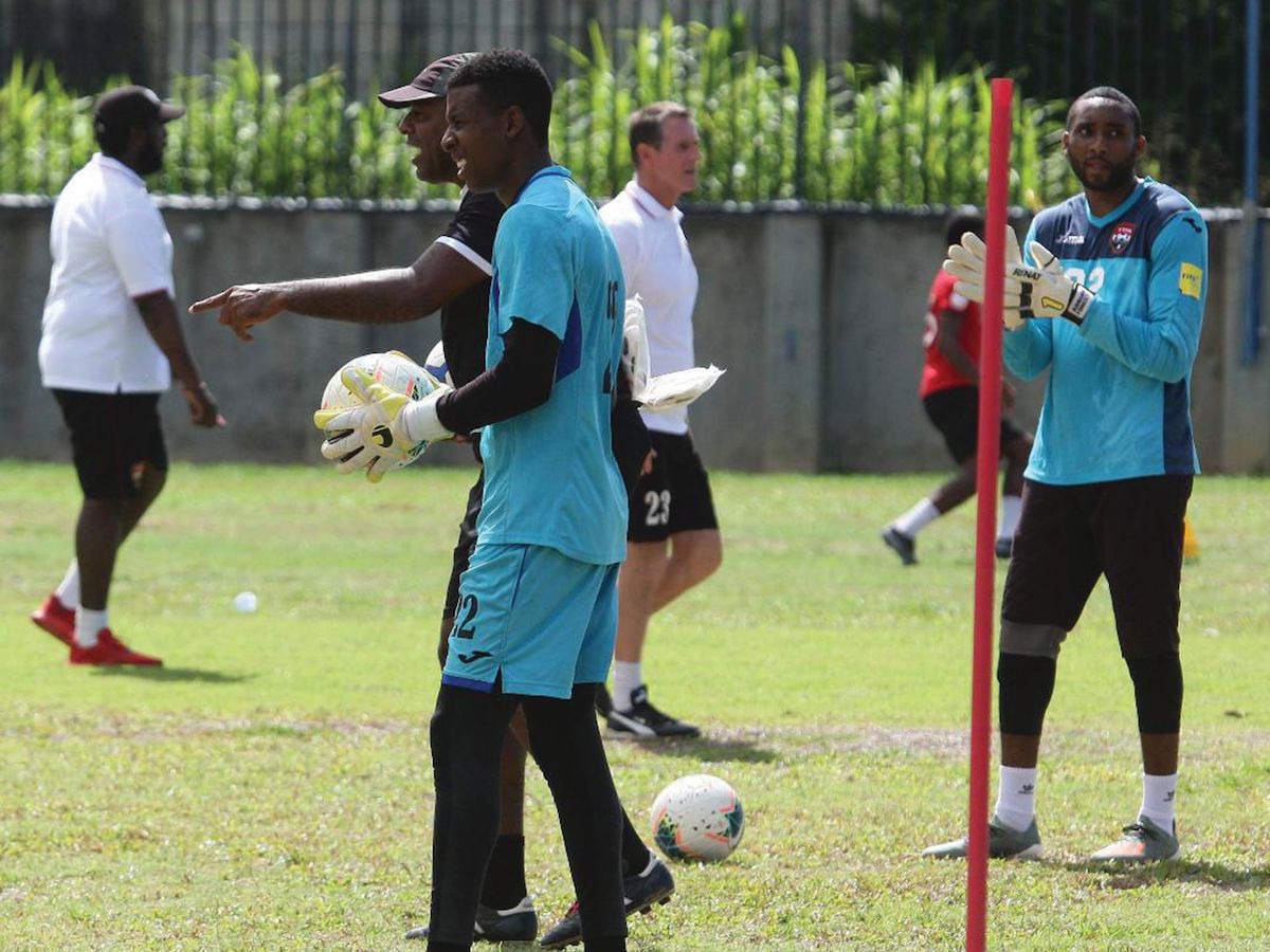Goalkeeper Adrian Foncette, right, and Andre Marchan, centre, listen to instructions from the coaches Adrian Romain, left, Terry Fenwick, centre in background, and Keith Jeffreys at the training session for the senior national football team in June at the St James Barracks, Port-of-Spain. PHOTO: Anthony Harris