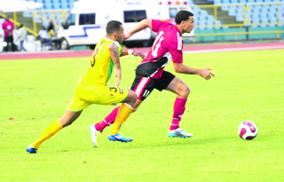 Carlos Edwards being chased by a Guyanese defender.