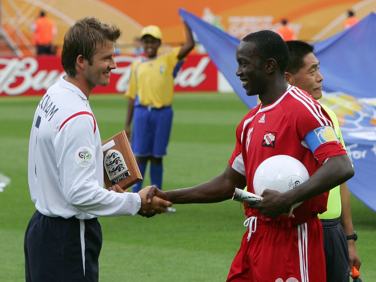Nurnberg, GERMANY: English midfielder David Beckham (L) shakes hands with Trinidad and Tobago's forward Dwight Yorke (R) before their opening round Group B World Cup football match at Nuremberg's Franken Stadium, 15 June 2006. England won the match 2-0. AFP PHOTO / ADRIAN DENNIS (Photo credit should read ADRIAN DENNIS/AFP via Getty Images)
